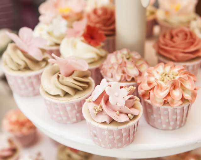 Floral cupcakes on cake stand at a wedding