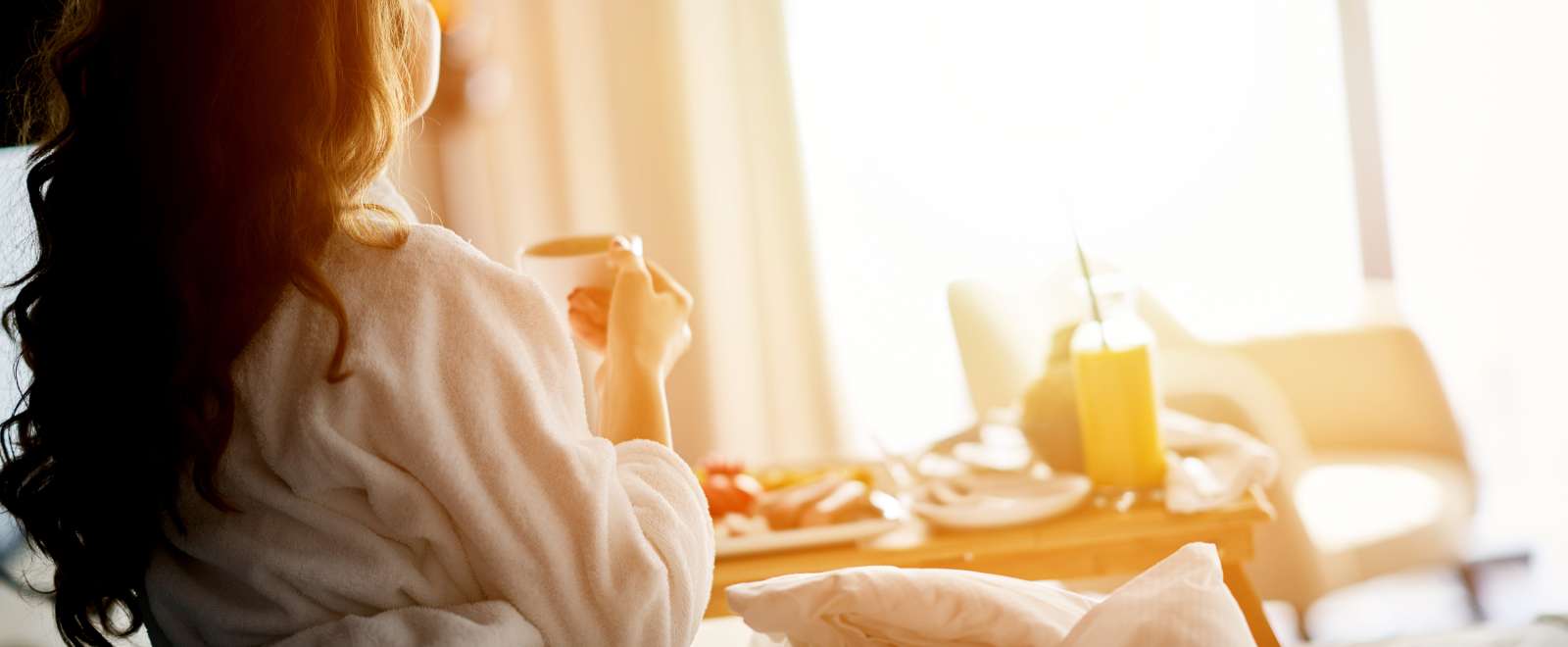 woman in bed eating breakfast