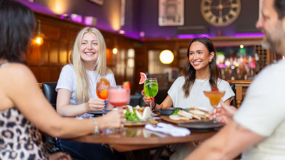 group of 4 eating and drinking in 62 the bank