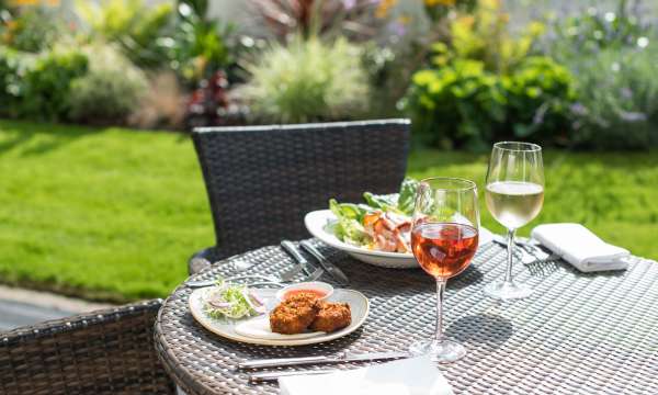 Two plates of food with wine outdoors at the Park Hotel in Barnstaple