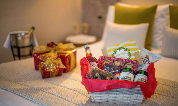 festive hamper and presents on bed