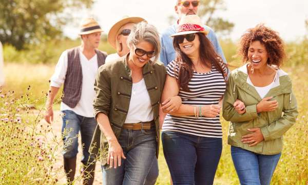 group of middle-aged people walking in a field