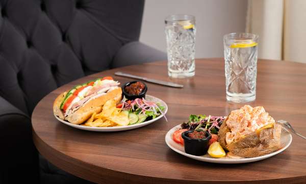 baguette and prawn jacket potato on a brown table