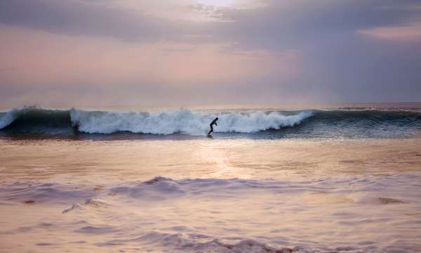 someone surfing alone on a wave