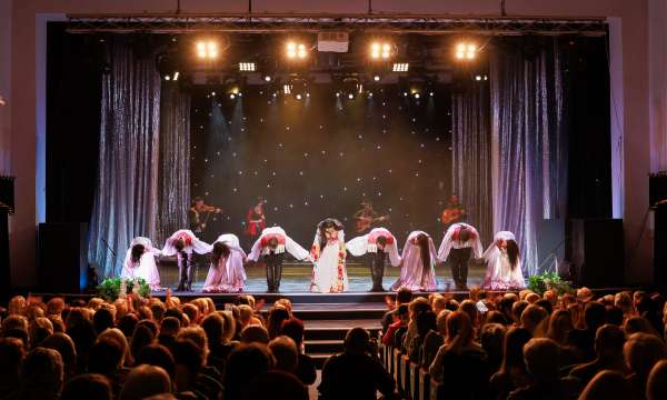 People bowing on stage at a theatre 