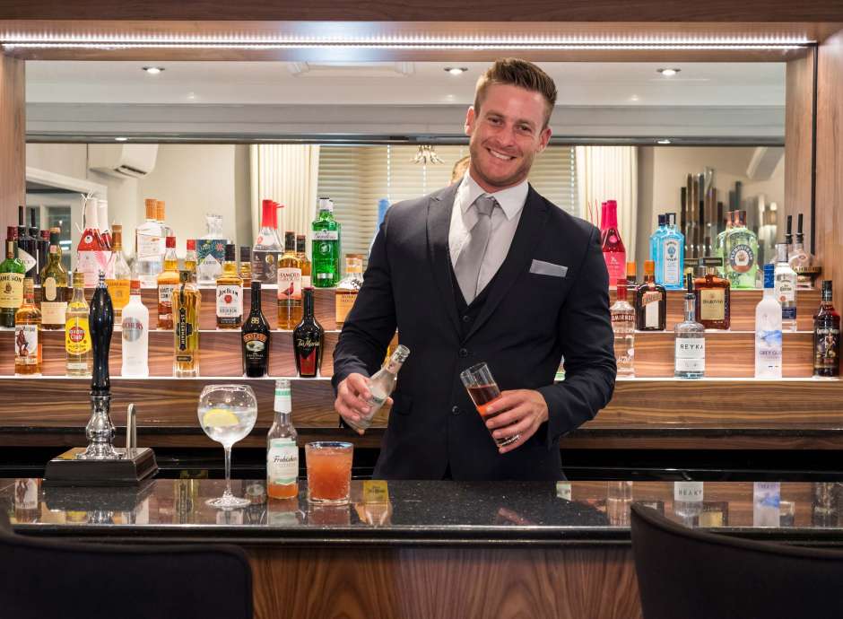 Royal and Fortescue Hotel Bar Manager Serving Drinks