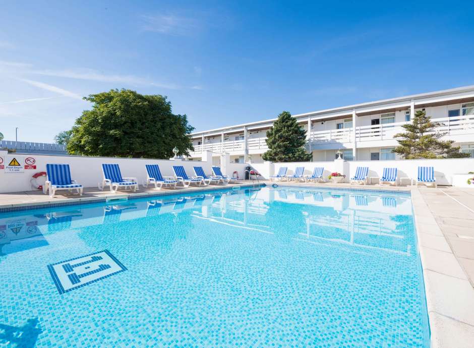 The outdoor swimming pool and sun loungers at the Barnstaple Hotel