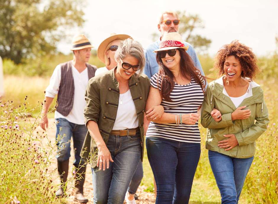 group of middle-aged people walking in a field