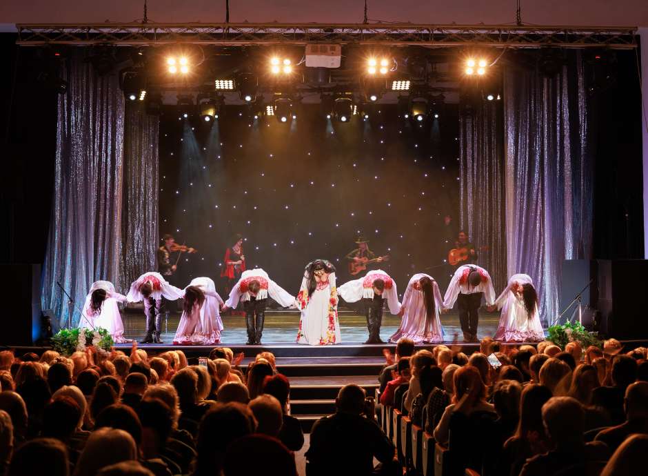 People bowing on stage at a theatre 