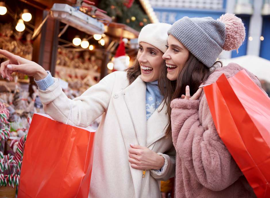 Two people shopping at a Christmas market