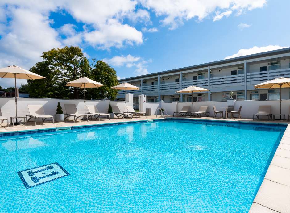 The outdoor swimming pool and sun loungers at the Barnstaple Hotel