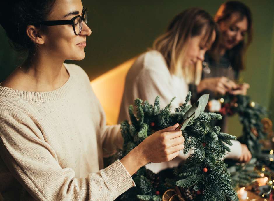 3 ladies making festive wreaths