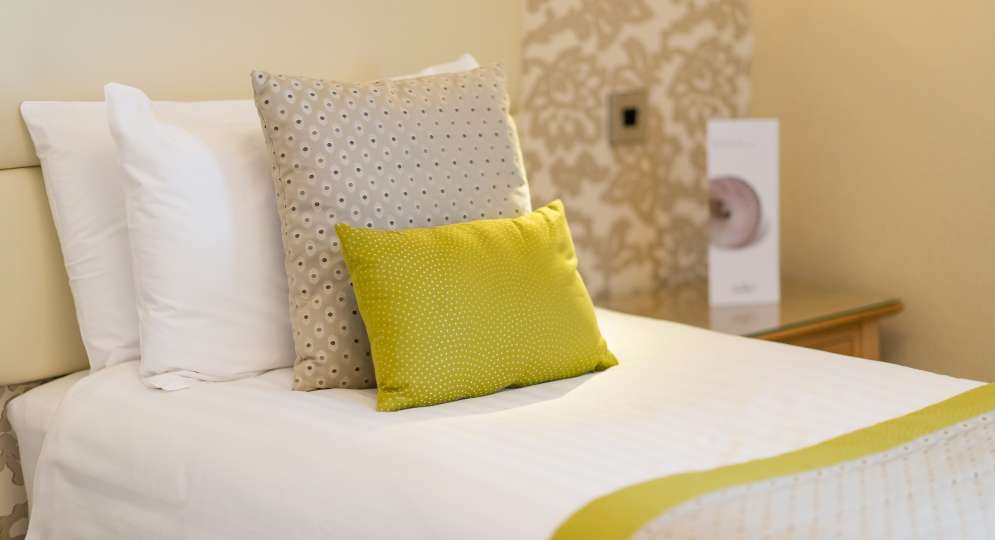 single bed with lime green cushion
