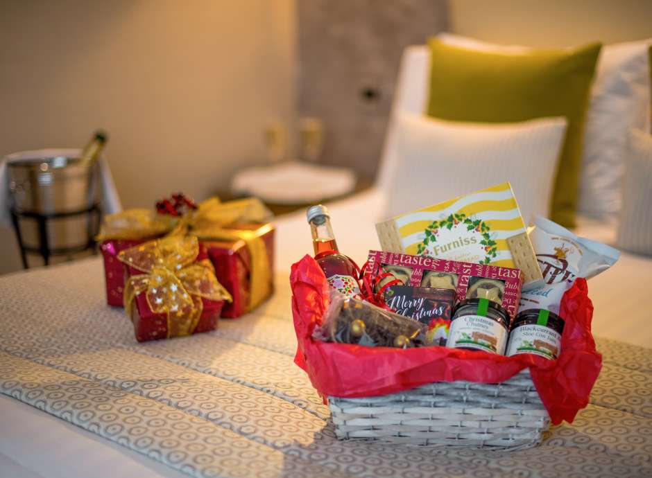 festive hamper and presents on bed